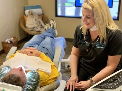 Vaca Dental team member talking with a patient during a dental check-up in Longview, TX