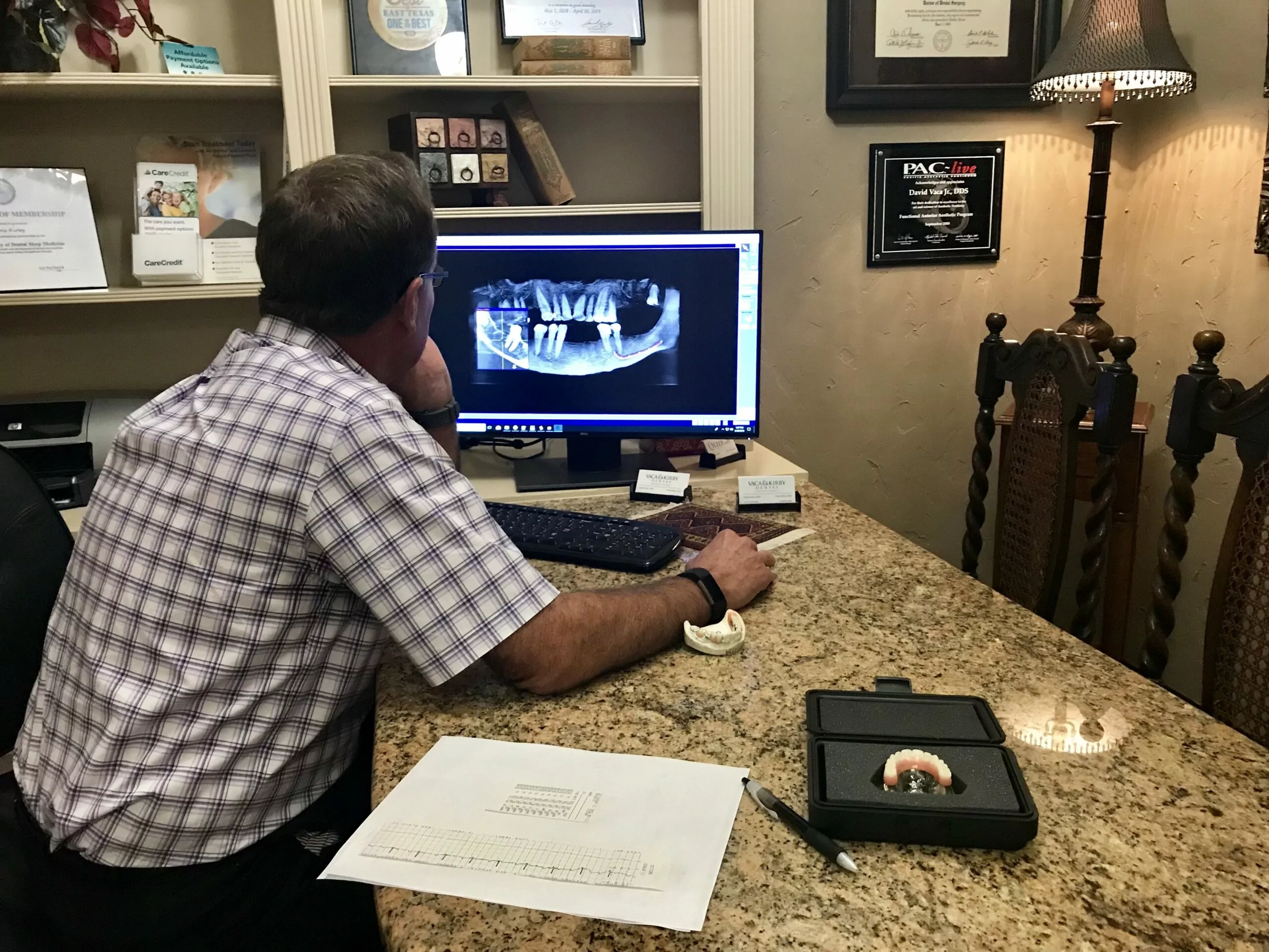 Dr. Kirby examining an x-ray on the computer