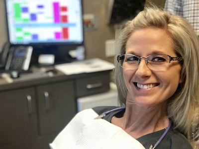 Longview dental implants patient smiles while visiting Vaca Dental