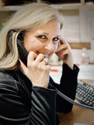 woman answering phone and smiling