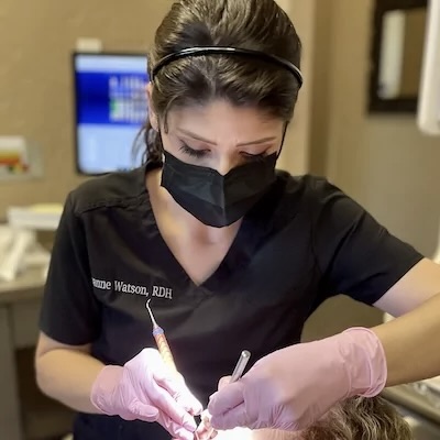 Dental Hygienist working on a patients smile