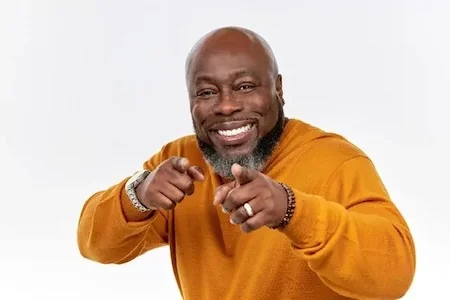 man smiling and pointing