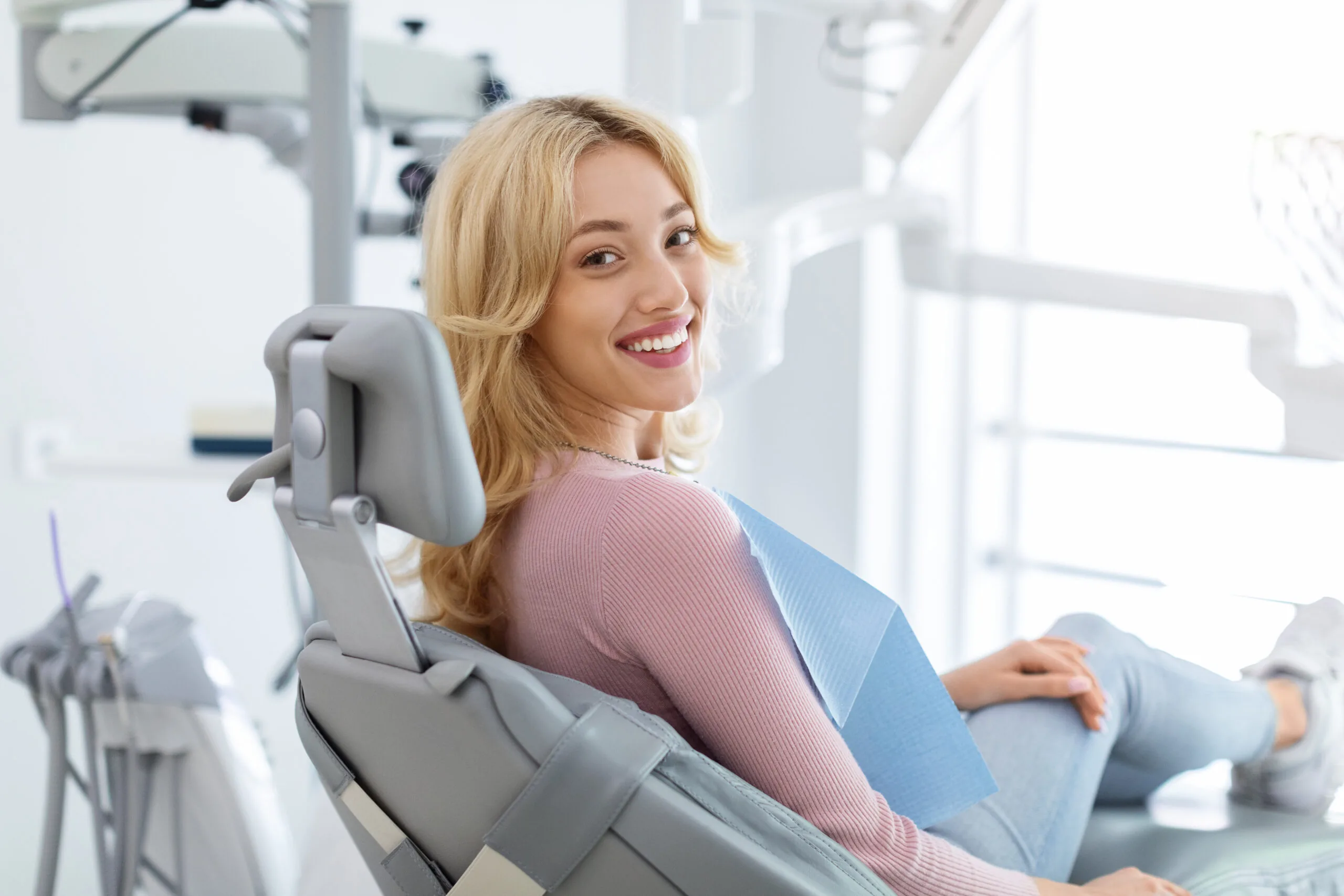 relaxed young woman smiling in a modern dental office
