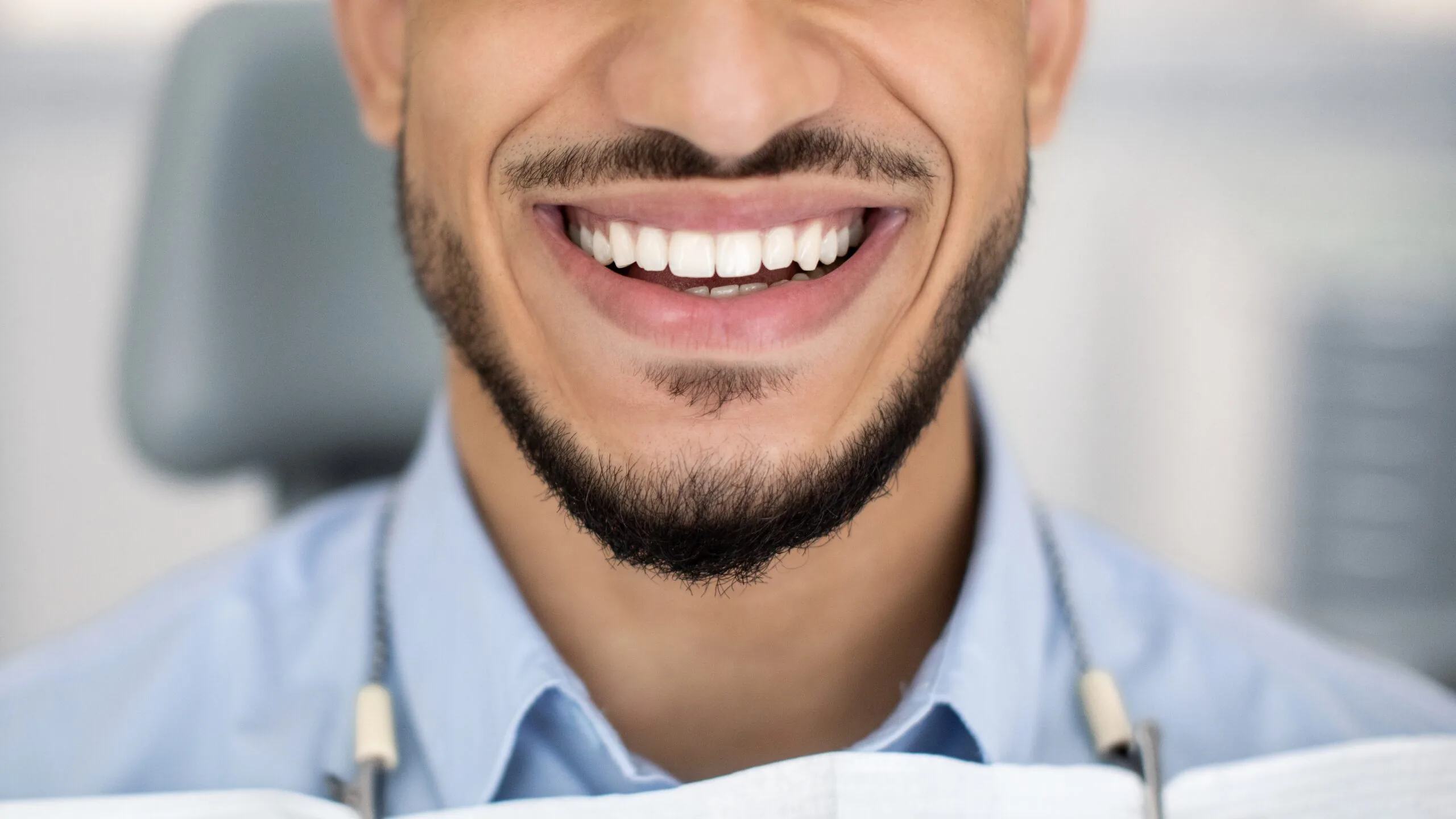 closeup of a young mans restored smile, dental crown