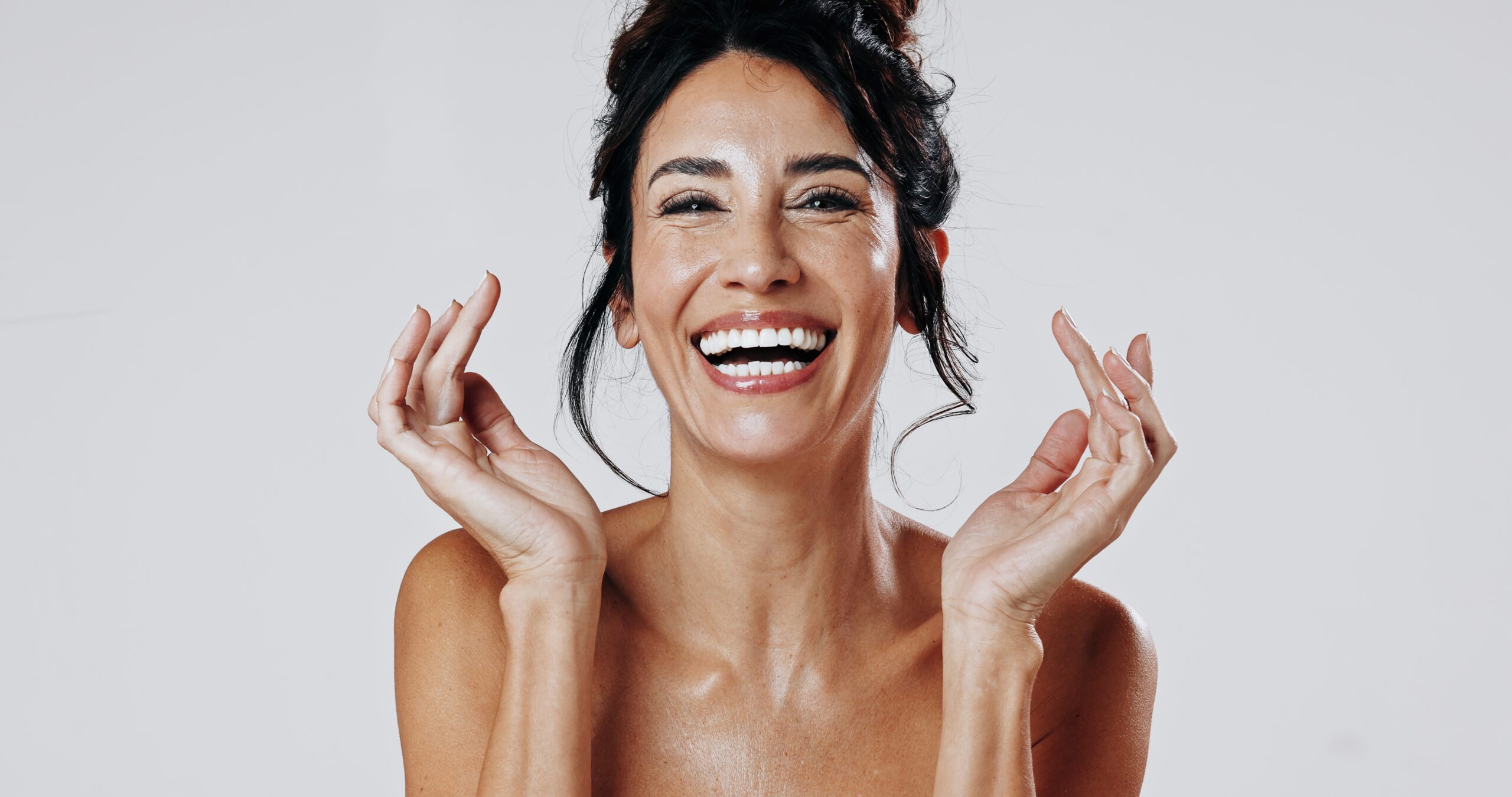 smiling woman showing perfectly bonded smile, white background